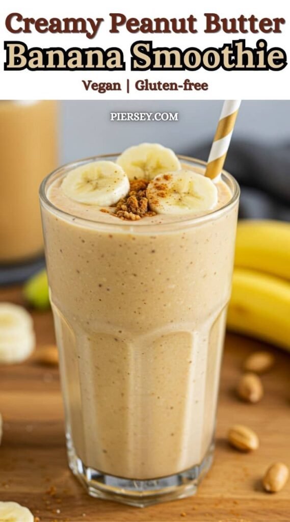 A creamy peanut butter banana smoothie in a glass, topped with banana slices and cinnamon. It's vegan, gluten-free, and has a striped straw.