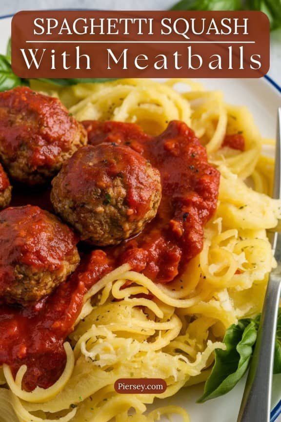 A plate of spaghetti squash topped with meatballs and rich red tomato sauce. Fresh basil adds a pop of green, creating a vibrant and appetizing dish.