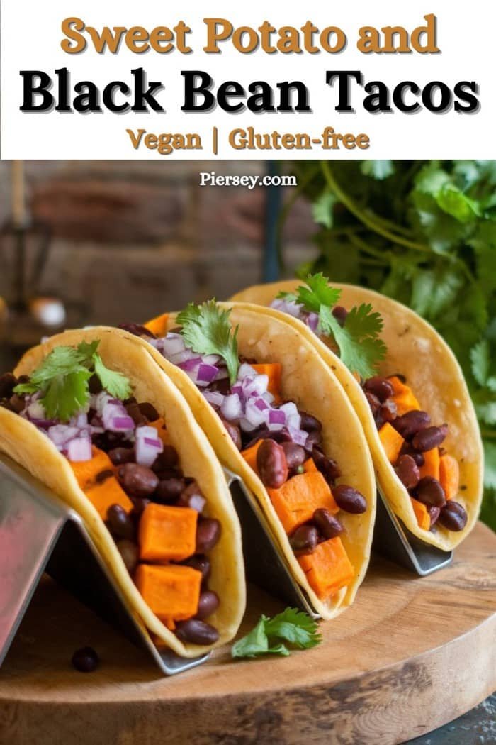 Three vegan tacos filled with diced sweet potatoes, black beans, red onions, and cilantro on a wooden board. Text reads "Sweet Potato and Black Bean Tacos."