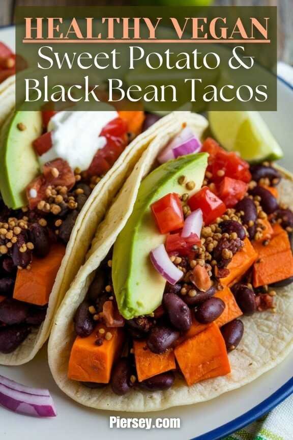 Close-up of vegan sweet potato and black bean tacos, topped with avocado, tomatoes, and red onions. The text reads "Healthy Vegan Sweet Potato & Black Bean Tacos."