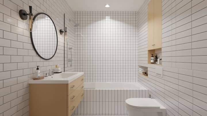 A modern bathroom with white subway tiles, a wooden vanity with a round mirror, and a bathtub. Ambient lighting creates a clean, minimalist atmosphere.