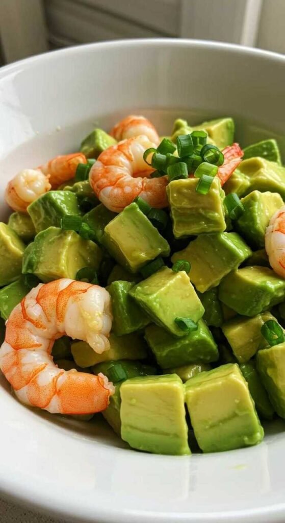 Avocado and shrimp salad garnished with spring onions