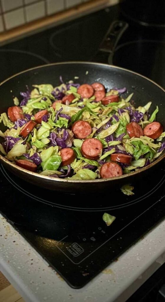 A delicious Cabbage and Sausage Skillet on the stove.