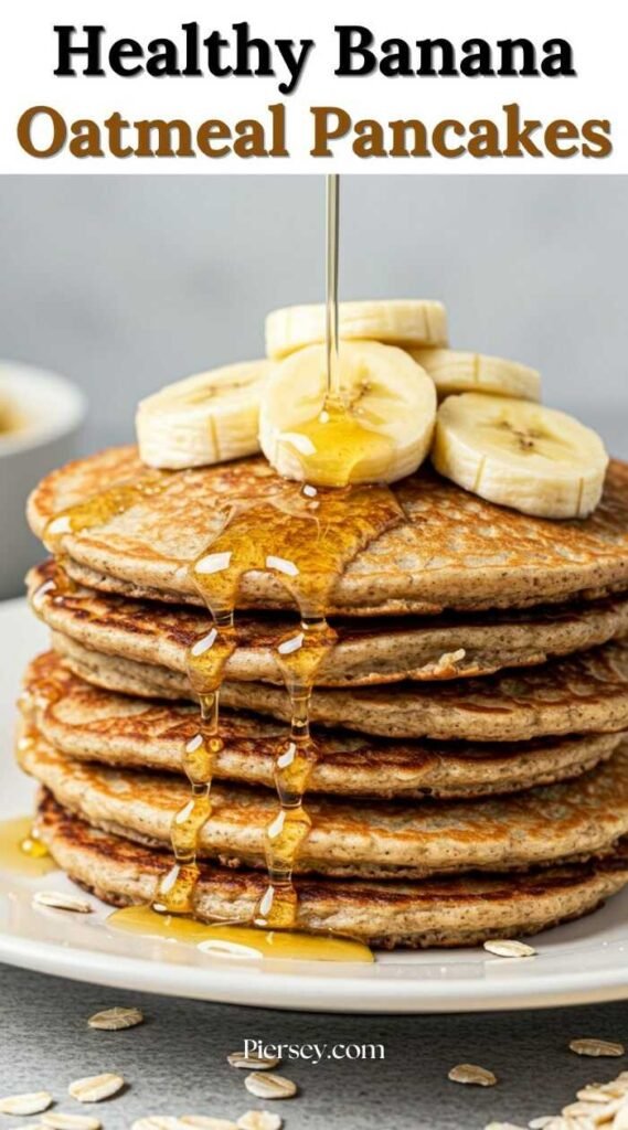 Stack of oatmeal pancakes topped with banana slices, drizzled with syrup. The text above reads "Healthy Banana Oatmeal Pancakes." Inviting and delicious.