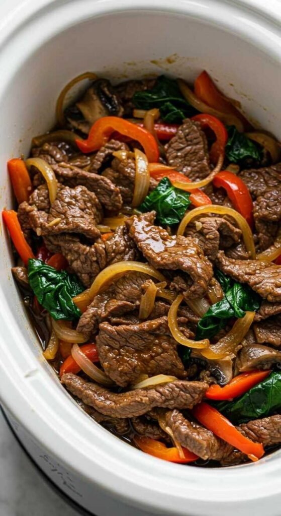 A delicious serving of Korean Beef Bulgogi in a crockpot with vegetables.