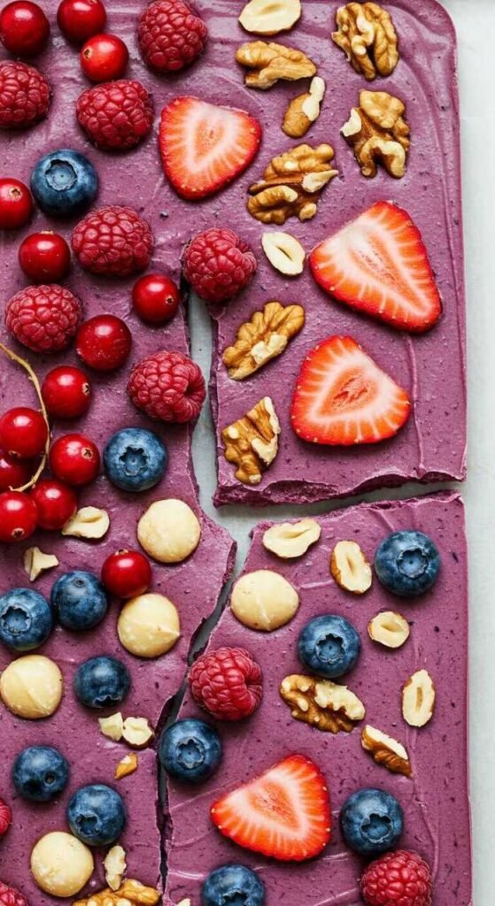 Frozen yogurt bark topped with nuts and berries.