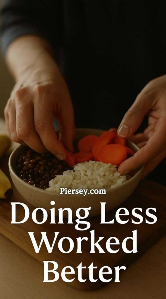 Two hands prepare a bowl with rice, lentils, and sliced carrots. The phrase "Doing Less Worked Better" is overlaid. The mood is calm and minimalistic.