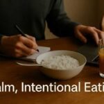 Is the Rice Diet Misunderstood? Let’s Clear It Up A person writes in a notebook beside a bowl of rice and a glass of orange juice on a wooden table. Text overlay reads "Calm, Intentional Eating."
