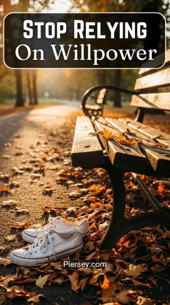 White sneakers rest on a park path covered with autumn leaves next to a bench. The text reads "Stop Relying On Willpower." Warm, motivational tone.