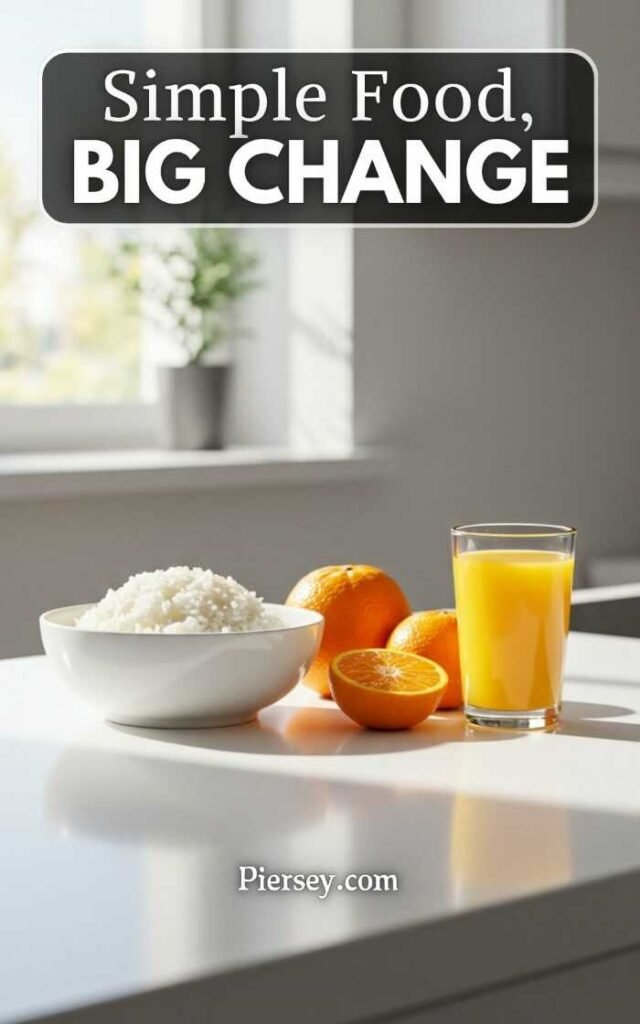 Bowl of rice, oranges, and a glass of orange juice on a sunlit kitchen counter. Text overlay: "Simple Food, Big Change." Bright and inviting.